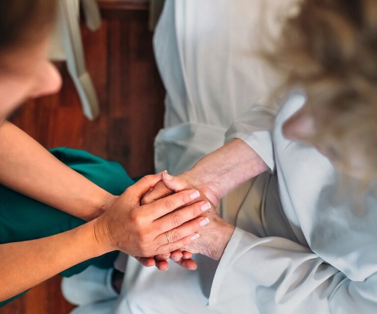 Doctor giving encouragement to elderly patient